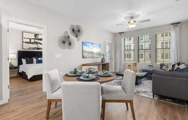 A modern living room with a dining table set for four.at Century Grove Park, Knightdale, 27545