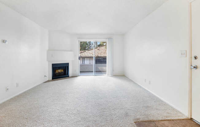 Carpeted Living Room with Balcony and Fireplace