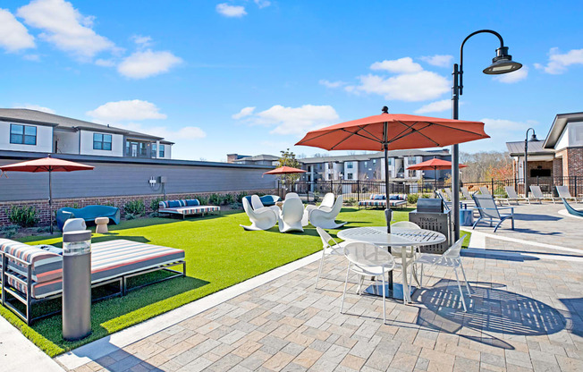 a patio with tables and chairs and umbrellas