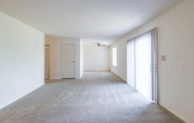 Living and dining room with patio access in the 2 bedroom apartment at Woodbridge Apartments