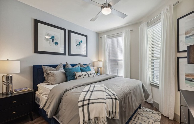 a bedroom with a large bed and a ceiling fan at LynnCora, Grand Prairie, Texas