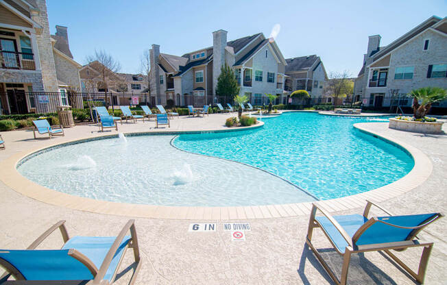 swimming pool with sun deck and chairs