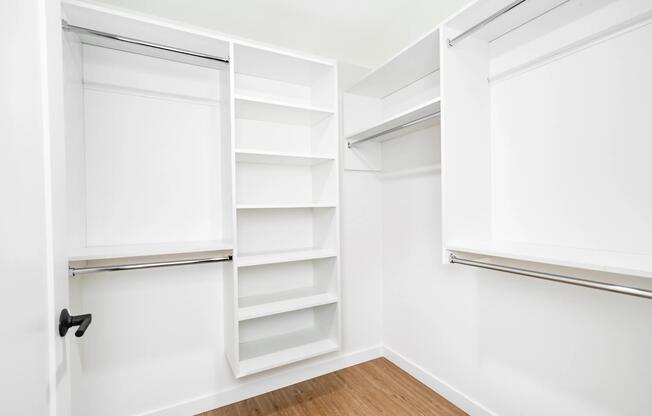 Spacious closet with built-in shelving and hanging space, offering a streamlined solution for organized storage and everyday ease.