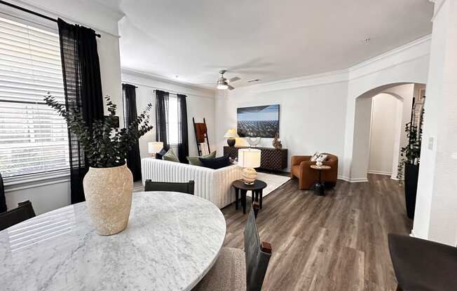 a living room and dining room with a marble table