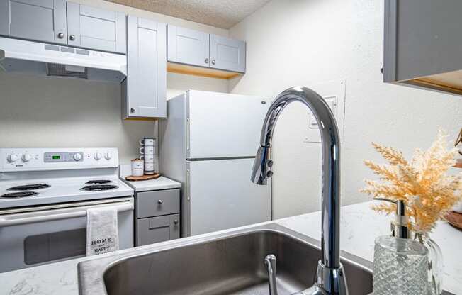 The Willows Apartments kitchen with white appliances and a sink