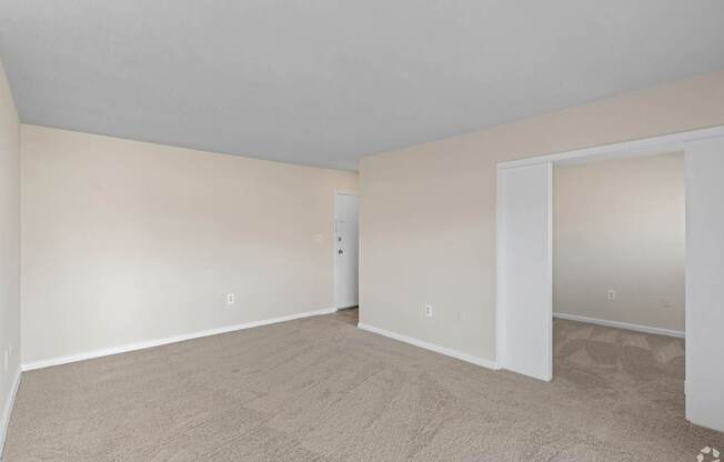 A room with a carpeted floor and white walls.