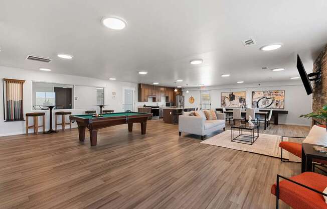 A room with a pool table and a couch.