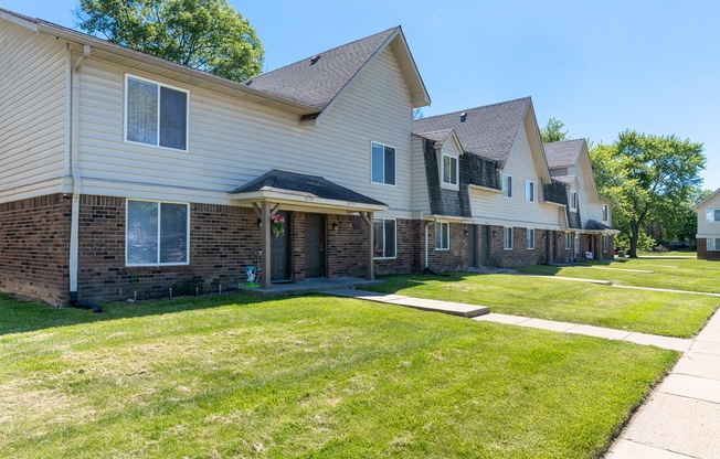 a row of houses on the side of a sidewalk