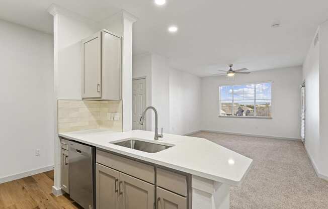 an empty kitchen with a sink and a window