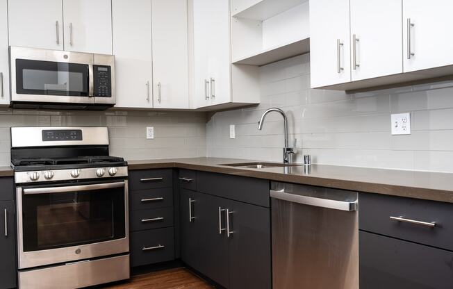 Kitchen with white upper cabinets and stainless appliances