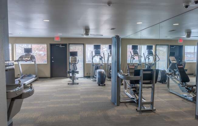 a gym with weights and cardio equipment in a building