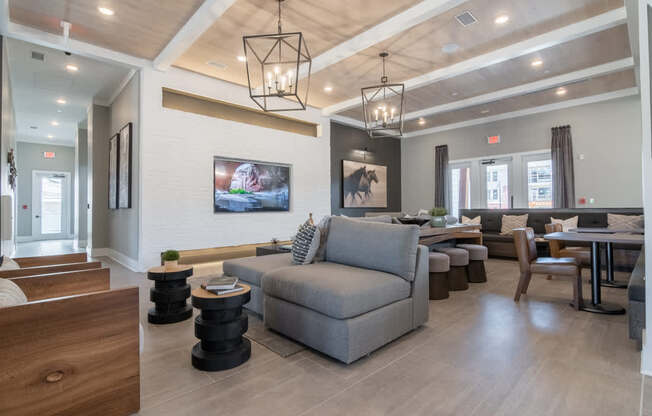 a living room with couches and chairs and a table and a tv