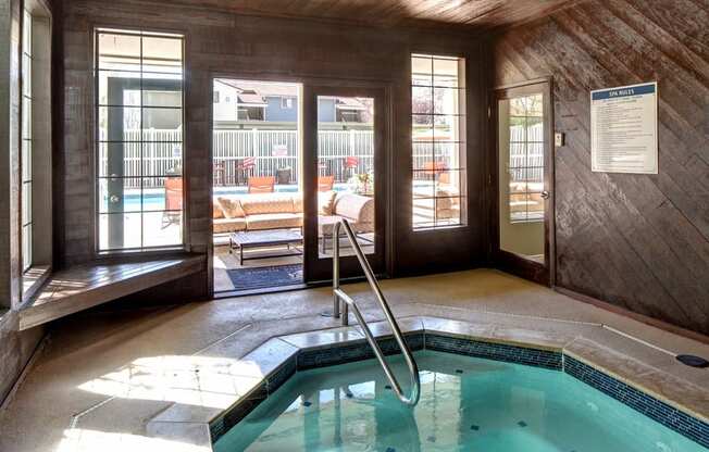 an indoor spa with a door to the outdoor pool area at 2000 Lake Washington Apartments, Renton, WA, 98056