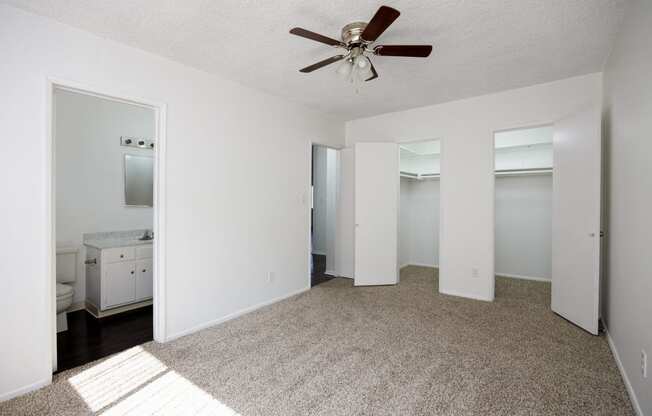 a living room with a rug and a ceiling fan