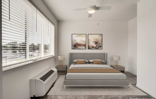 a bedroom with a bed and two windows