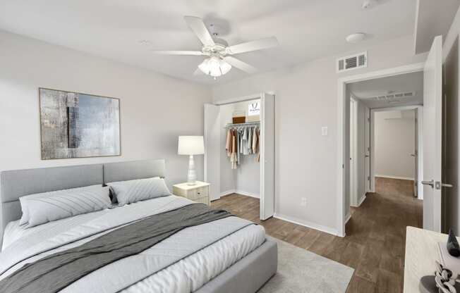 a bedroom with a large bed and a ceiling fan