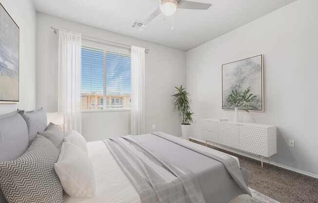 a bedroom with a large white bed and a large window