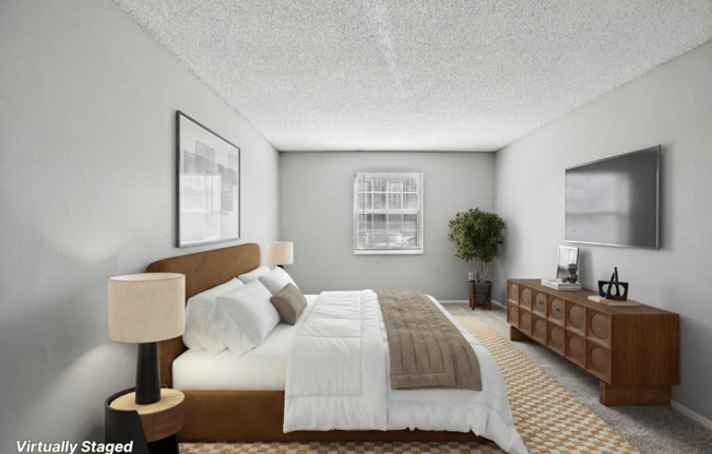 A bedroom with a bed, nightstand, and lamp.