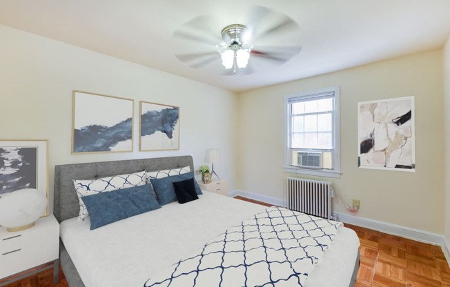 bedroom with bed, nightstands, ceiling fan, large closet and hardwood flooring at colonnade apartments in washington dc