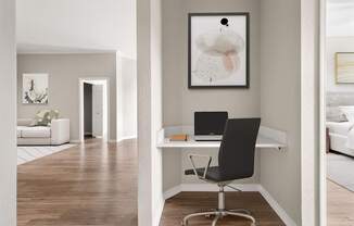 A black chair is in front of a desk with a laptop on it.