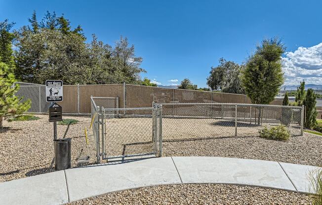 a fenced in area with a chain link fence and a parking meter