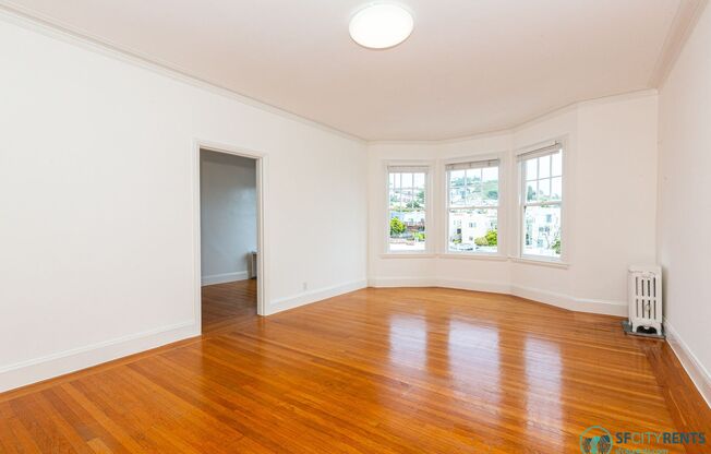 Sunset: Large Top Floor Studio Apartment with Onsite Laundry, Optional Parking, & City Views
