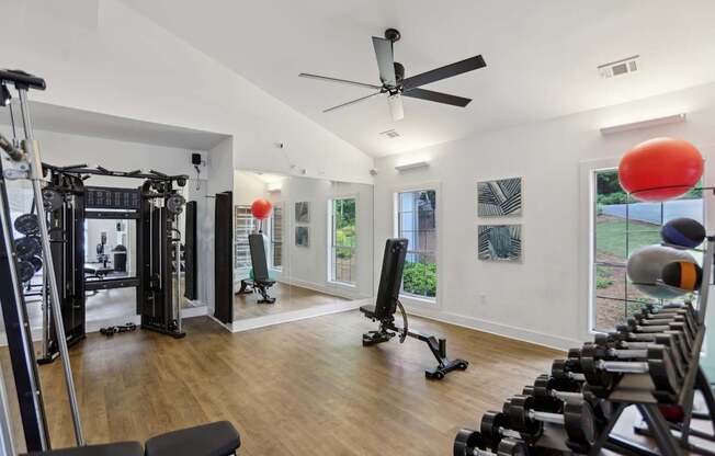 A gym with a variety of equipment including weights and a treadmill.