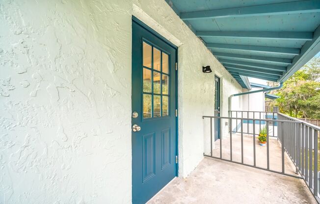 the front door of a building with a blue door