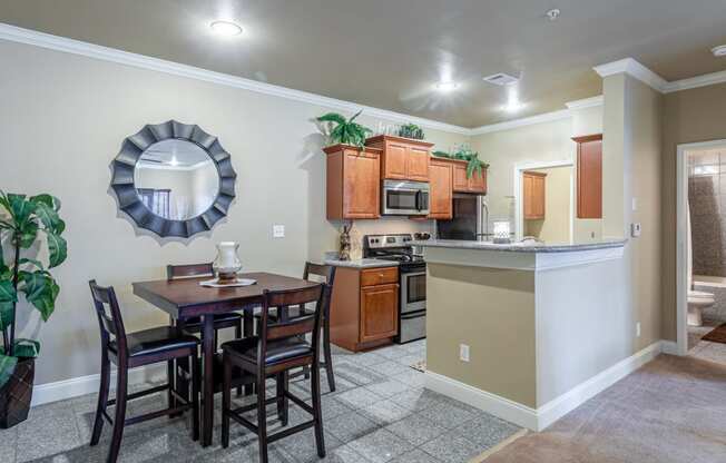 an open kitchen and dining area with a table and chairs