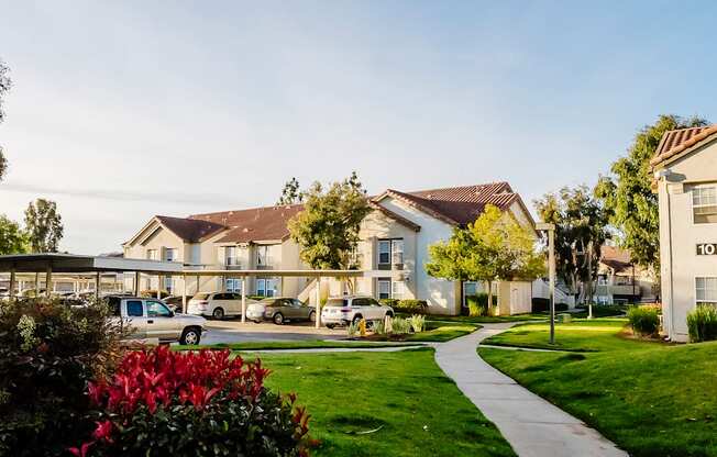 A residential area with houses and parked cars.