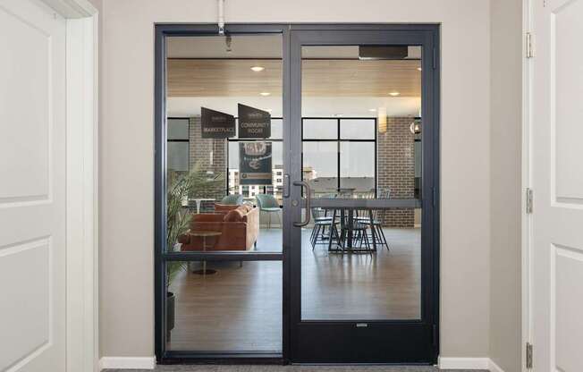 A glass door with a handle and a sign on it.