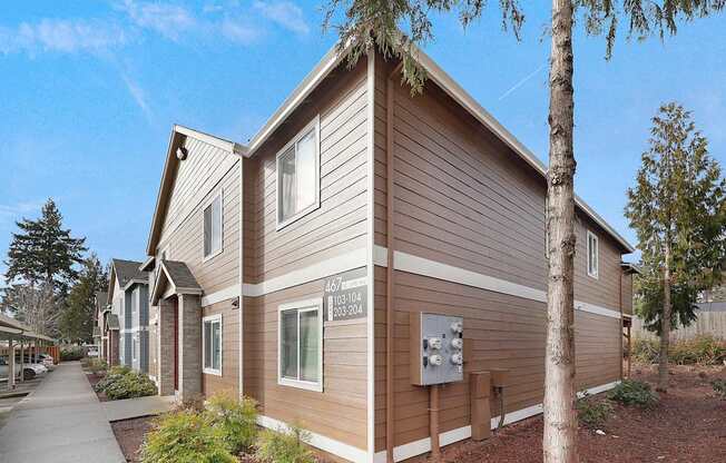 A brown house with a white door and windows.