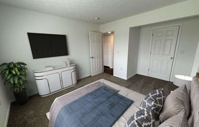 a bedroom with a large bed and a tv