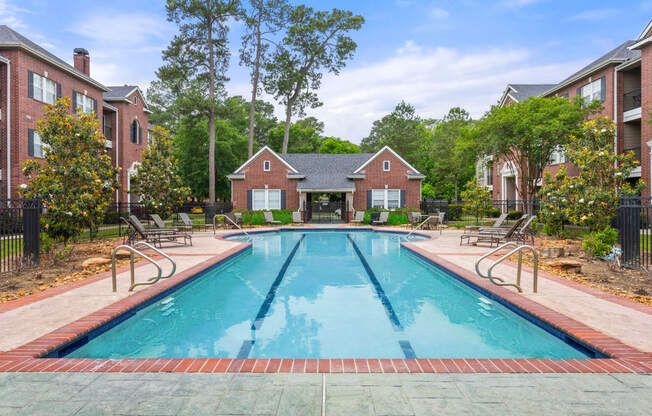 a swimming pool with a house in the background at Villages of Cypress Creek, Houston, Texas