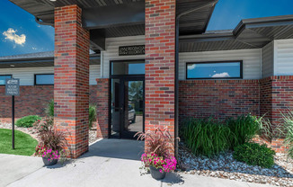 a person standing in front of a brick building