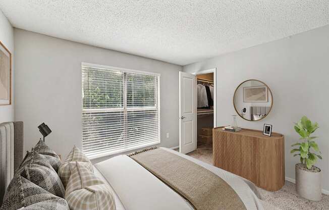 A bedroom with a bed, a dresser, and a mirror.