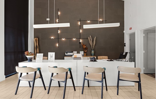 A modern kitchen with a white table and chairs. at Bridge at Tech Crossing, Texas