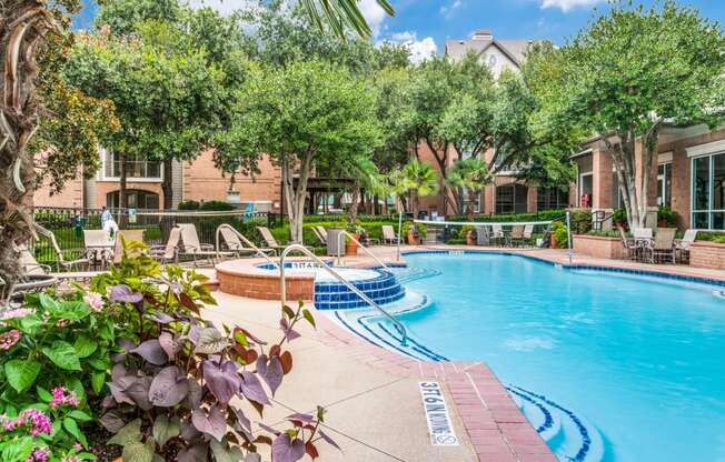 Apartments in North Dallas for Rent-Sparkling Swimming Pool With Volleyball Net Surrounded by Lounge Chairs and Seating