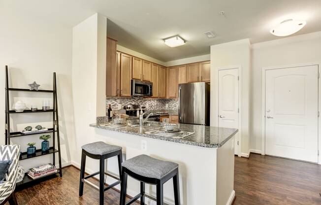 a kitchen with a counter top with two stools