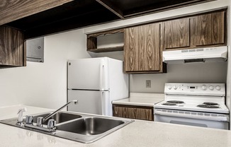 a kitchen with white appliances and a sink