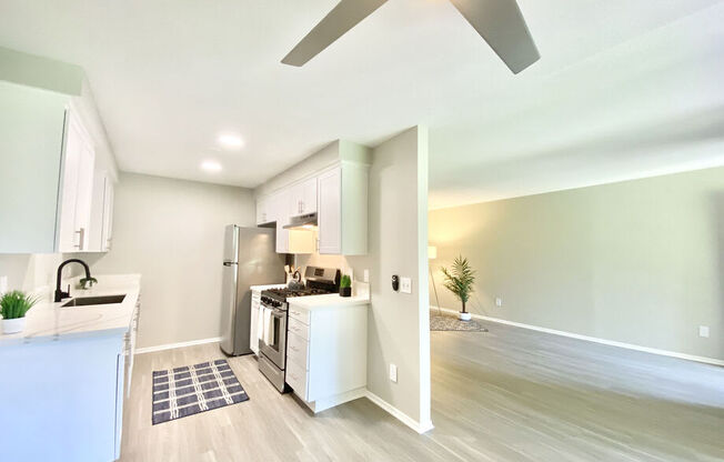 an open kitchen and living room with a ceiling fan at BLVD Apartments LLC, Tarzana California