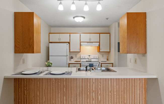 a kitchen with white appliances and wooden cabinets