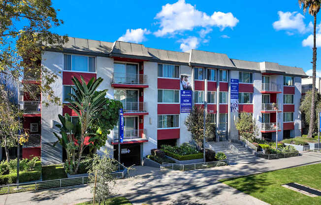A multi-story apartment building with a red and white exterior.