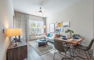 an open living room and dining room with a couch and a table