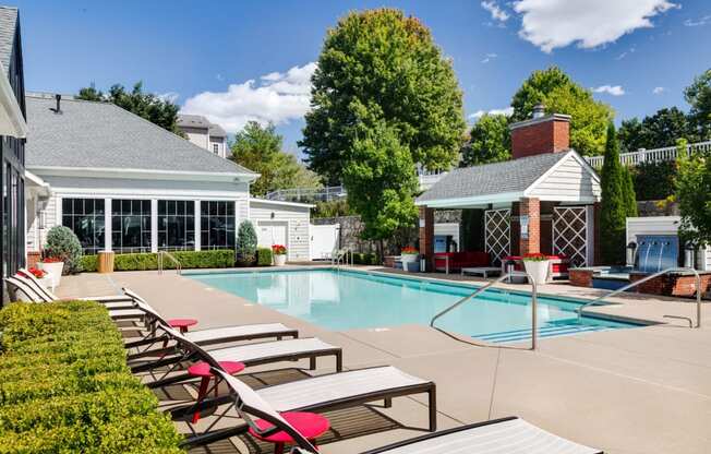 a swimming pool with lounge chairs next to a resort style pool at Residences at Stevens Pond, Massachusetts