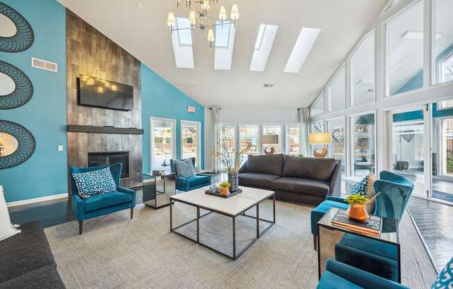 A living room with a fireplace and a large window.