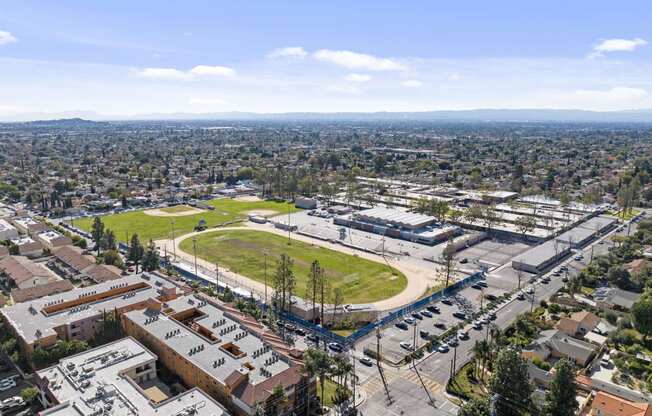 an aerial view of the city with a park and a field at Dronfield Astoria, 13140 Dronfield Ave