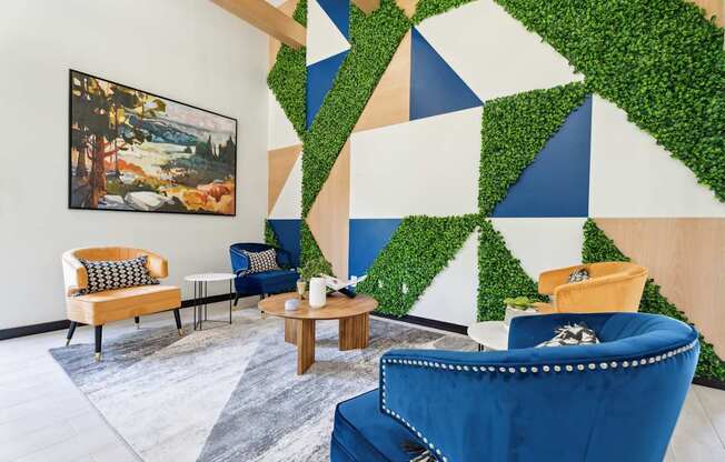 A living wall of greenery is on the wall behind a blue chair.
