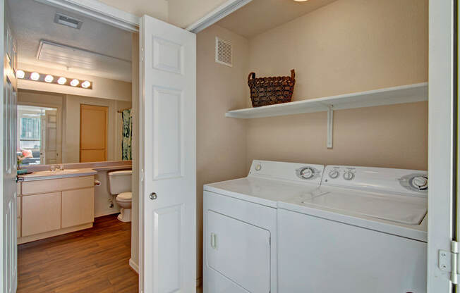 A white washer and dryer in a small laundry room.