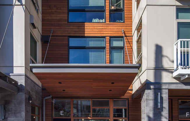 a building with a glass front door and a wood facade at The Hayes on Stone Way, Seattle, WA